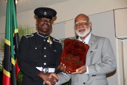 Top Constable of the Royal St. Christopher and Nevis Police Force, Nevis Division #601 Valentine Hodge receiving his recognition plaque from Governor General of St. Kitts and Nevis His Excellency Edmund Lawrence